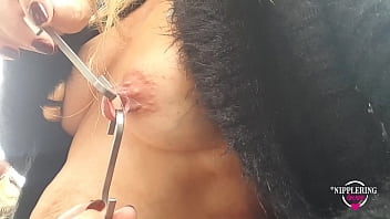 Sexy wife showcases extreme nipple piercings in outdoor setting